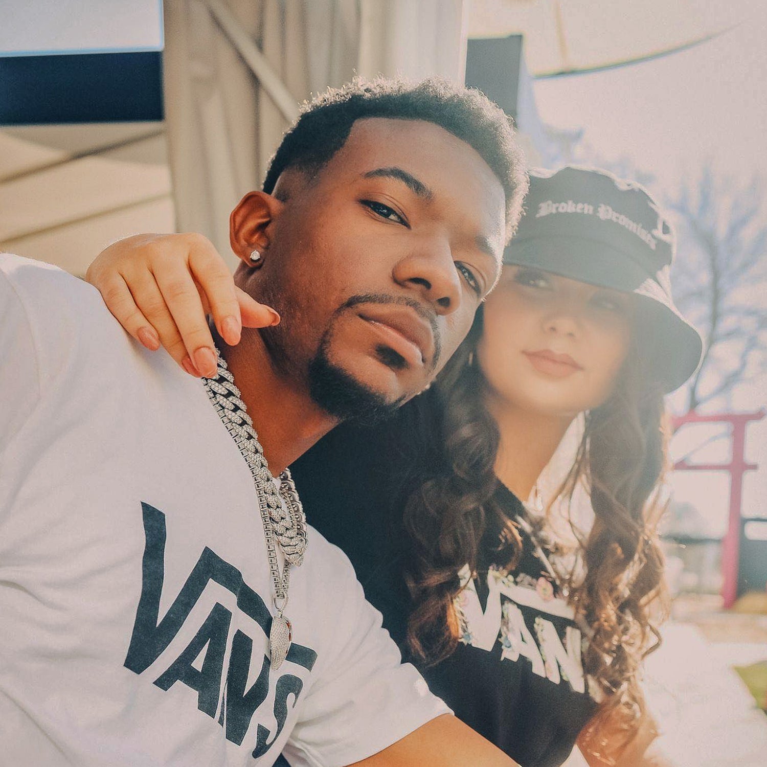 Two people standing close together with a blurred background